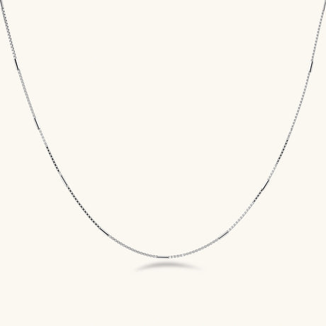 Delicate platinum-plated sterling silver necklace with alternating textured cubic links and smooth chain sections.