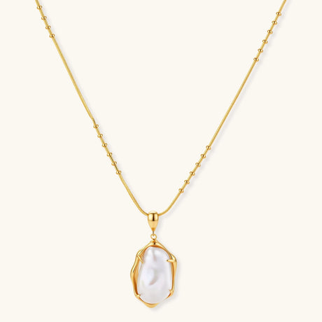 18K gold-plated sterling silver necklace with alternating bead chain and baroque pearl pendant on neutral background.