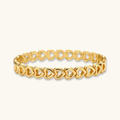 Gold 18K plated stainless steel bangle with continuous open heart links, high-polish finish, on white background.
